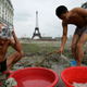 Construction workers bathe near apartment buildings in Tianducheng.